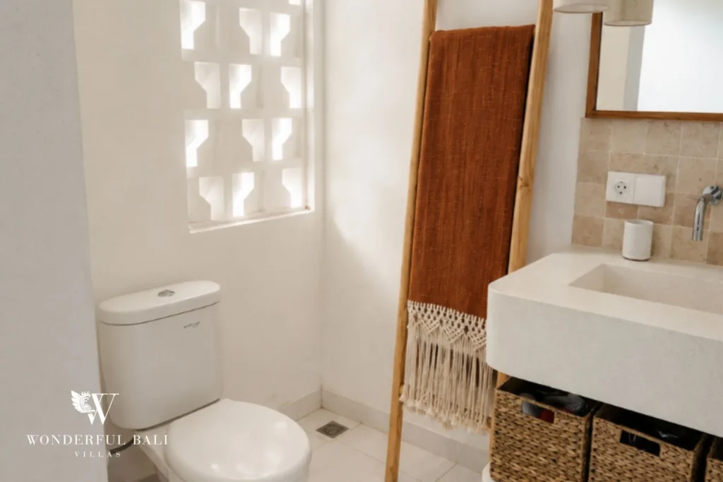 Second bathroom with breeze-block window and terrazzo basin in a 2-bedroom villa in Cemagi Bali