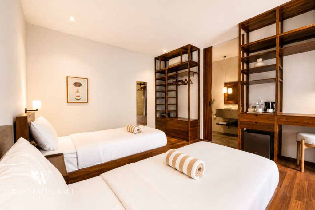Twin bedroom with two single beds and poolside access at a villa in Berawa, Canggu