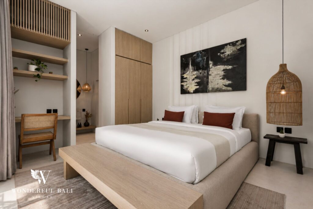 En-suite king bedroom with framed artwork at a villa in Petitenget, Seminyak