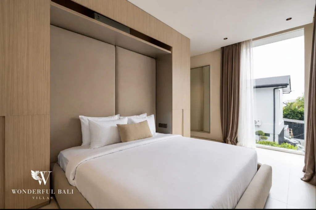 Bedroom with timber panelling and full-height window at a modern villa in Umalas, Bali