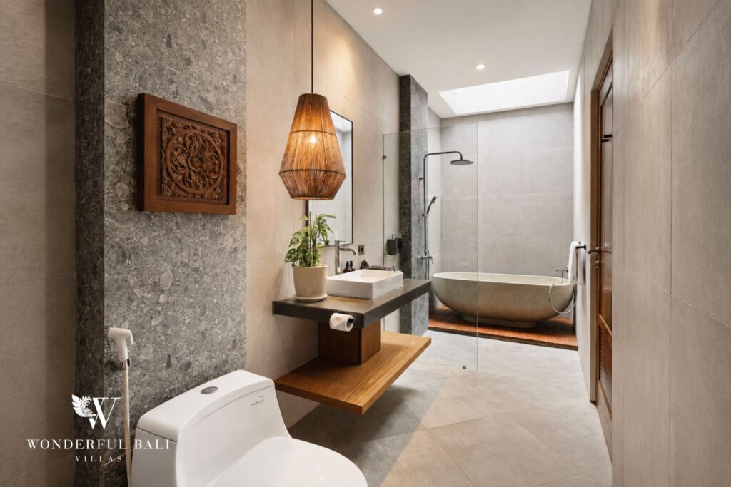 En-suite bathroom with stone feature wall at a villa in Canggu