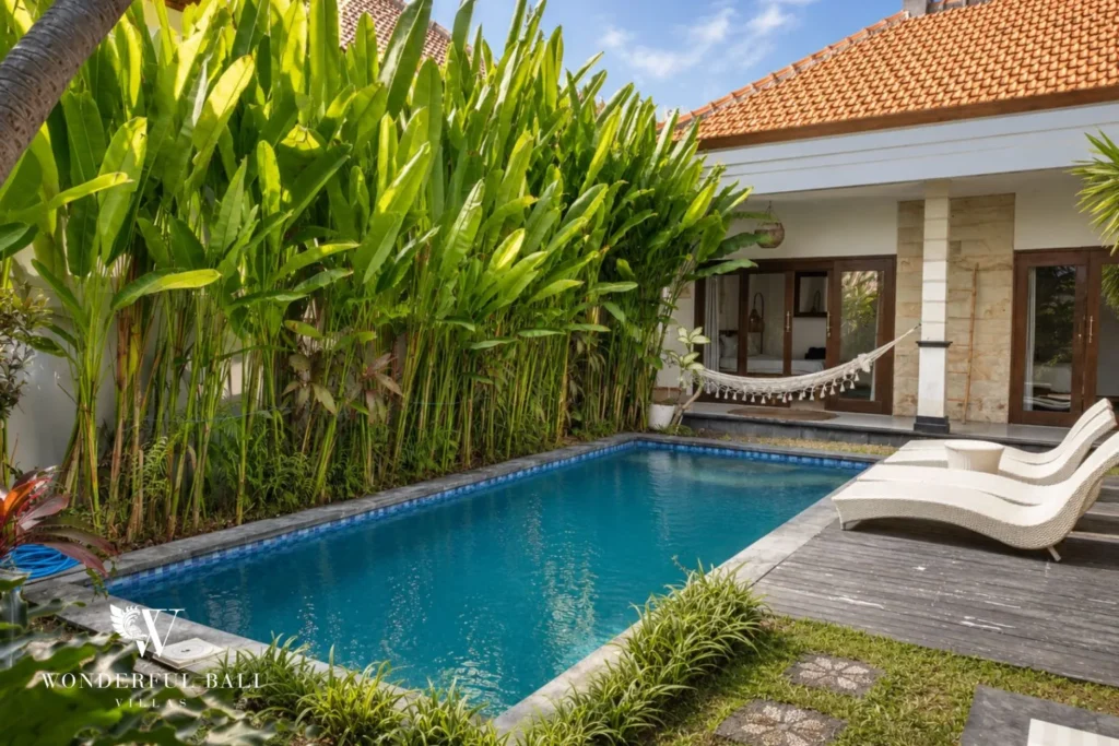Private pool with sun loungers and tropical garden at a villa in Batu Bolong, Canggu