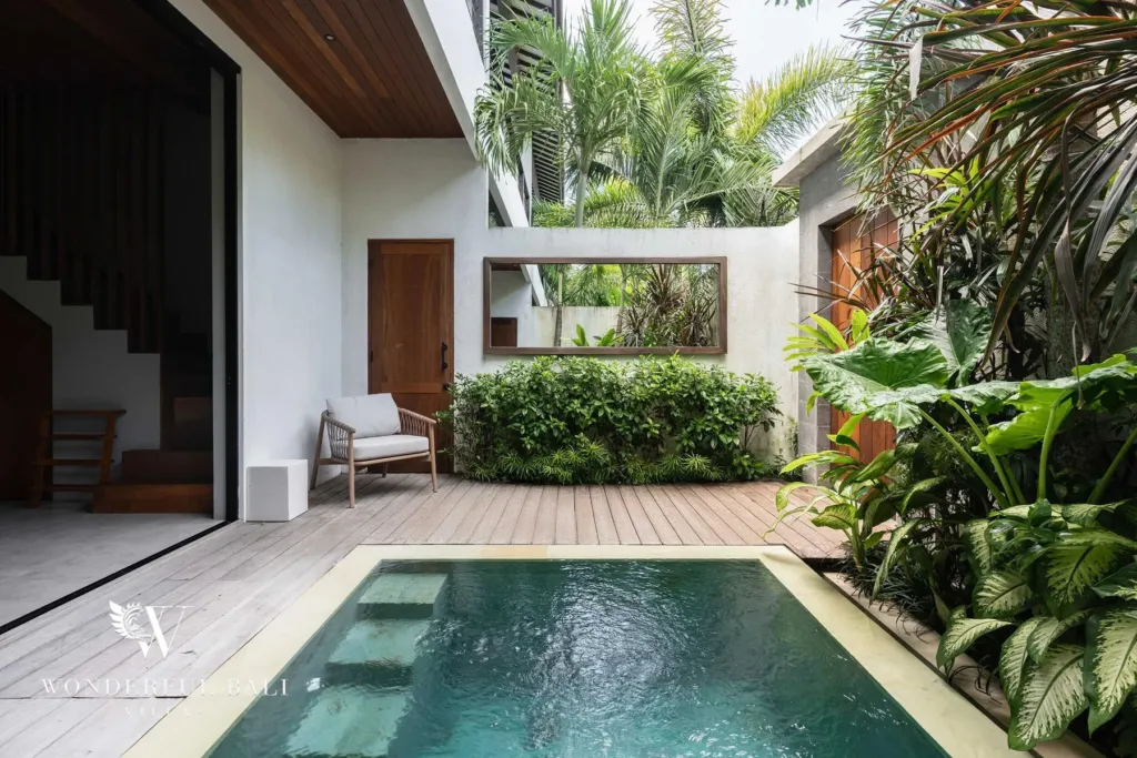 2BR villa for rent in Pererenan — pool, a private saltwater plunge pool with stone steps set into a timber deck alongside tropical foliage and a wood staircase at a 2-bedroom villa