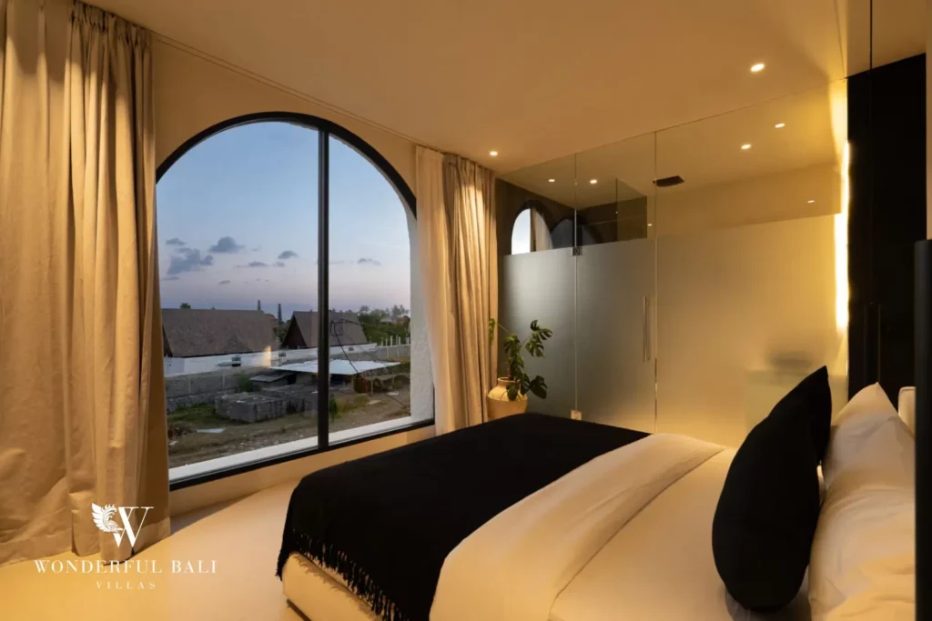 3BR ocean-view villa in Seseh — bedroom with arched window and view