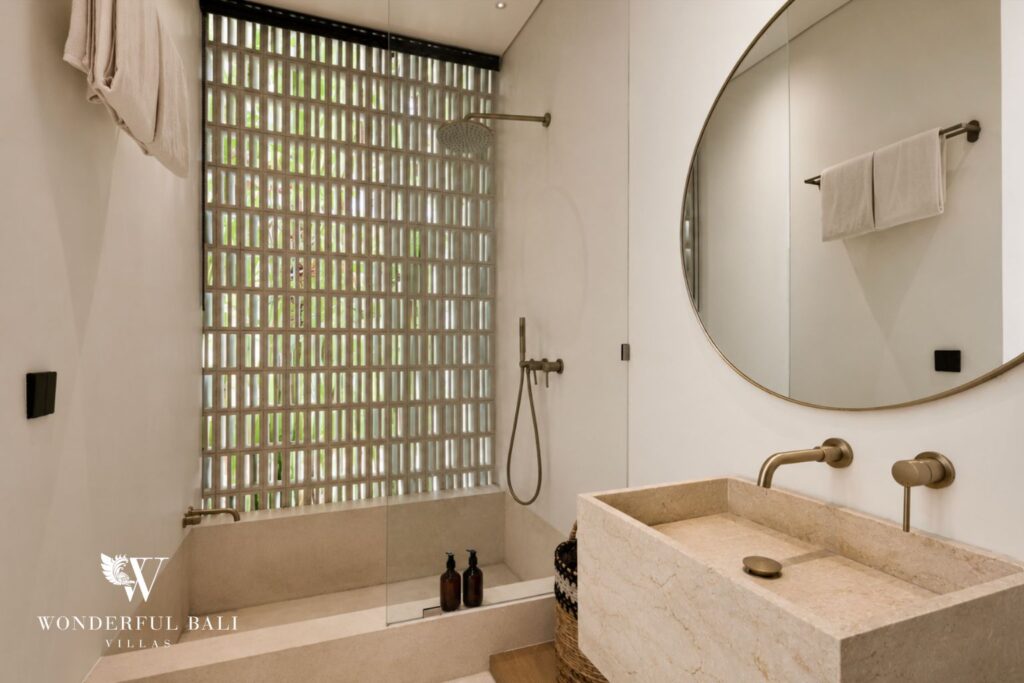 En-suite bathroom with vanity and mirror at a villa in Petitenget, Seminyak