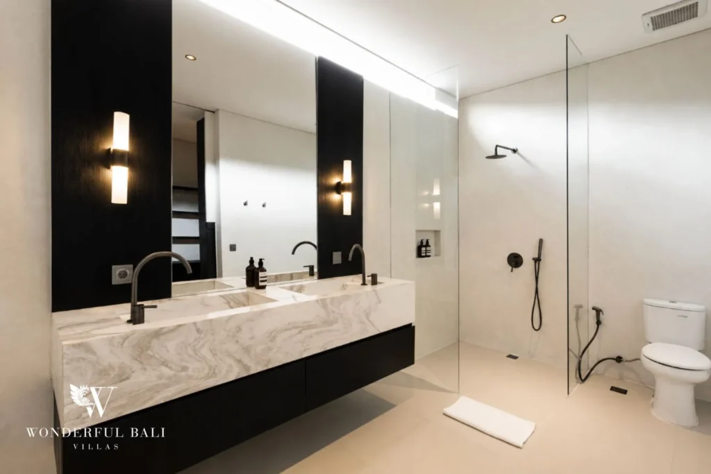 En-suite bathroom with walk-in rain shower and marble double vanity at a villa in Umalas, Bali