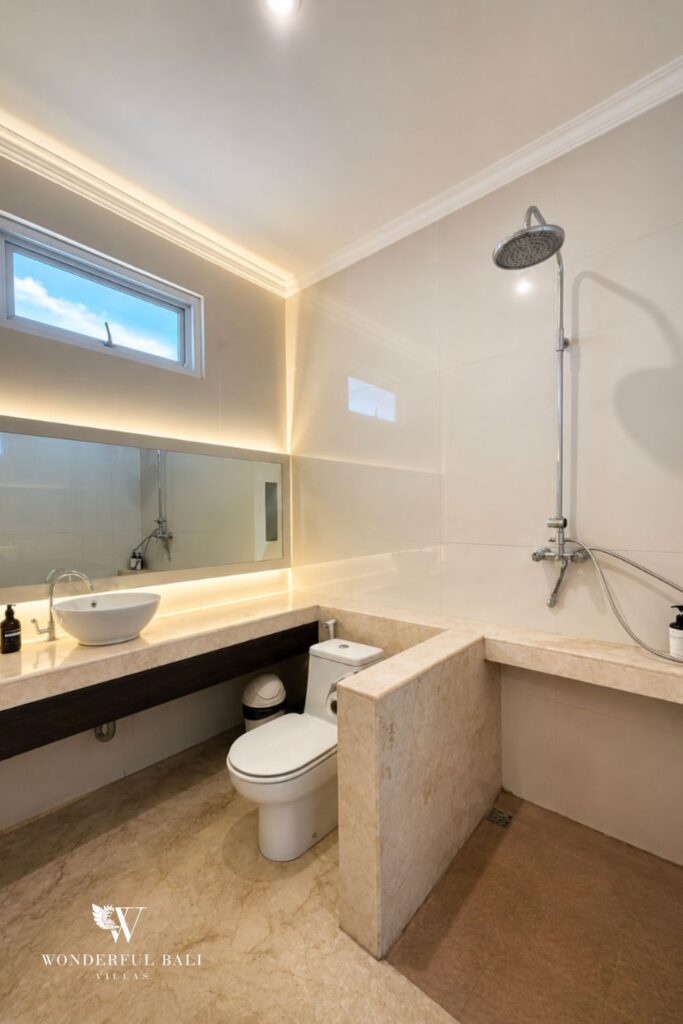 En-suite bathroom with vanity and shower at a villa in Seminyak