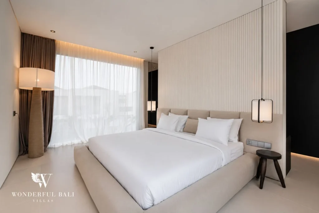 Bright en-suite bedroom with sheer curtains and floor lamp at a modern villa in Umalas, Bali