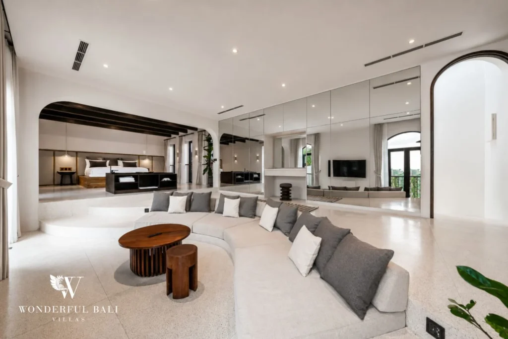 Master bed on a raised platform under exposed beams in a 4-bedroom villa in Canggu Bali