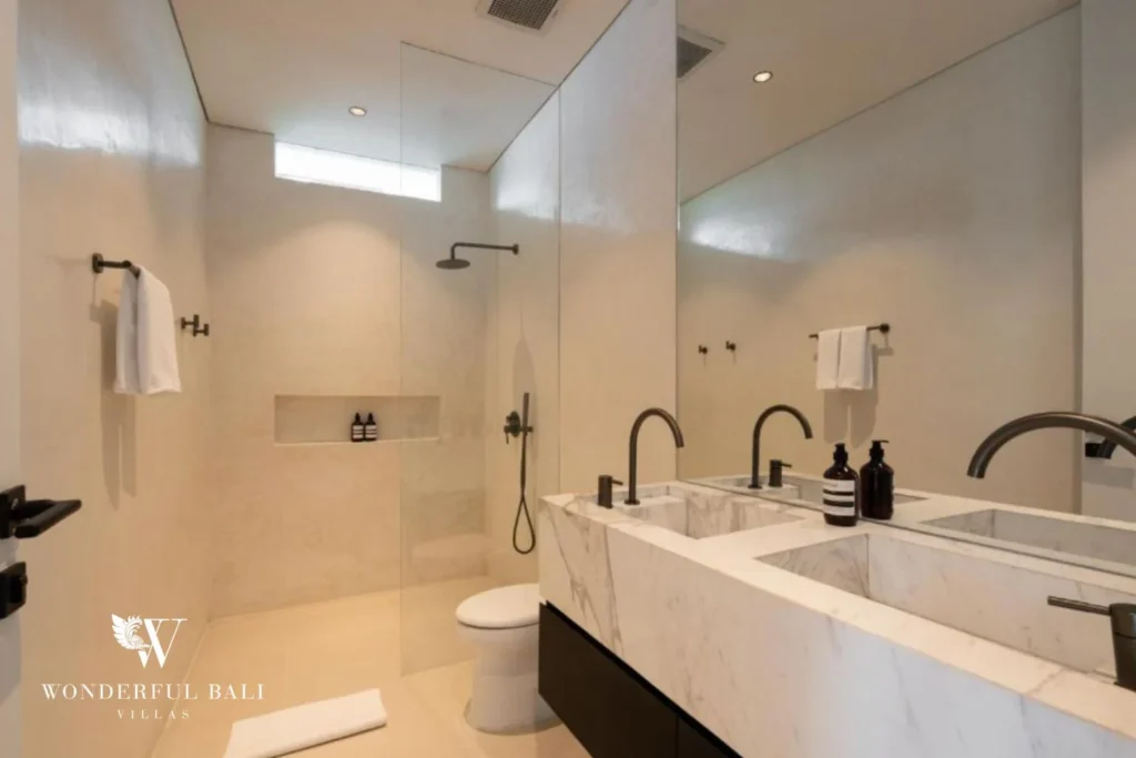 Bathroom with walk-in shower and marble vanity at a modern villa in Umalas, Bali
