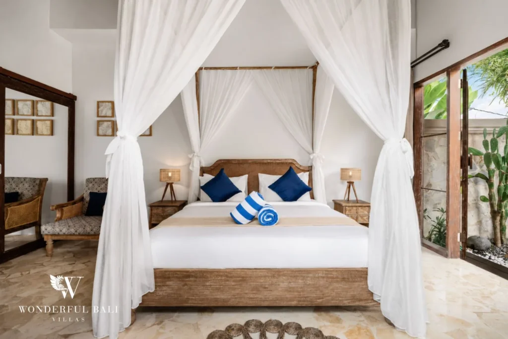 3BR tropical villa in Pererenan — bedroom with canopy bed and garden access