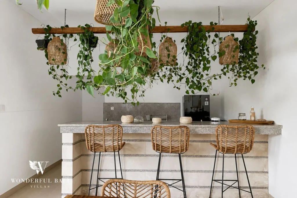 Boho breakfast bar with rattan stools and hanging plants at a villa in Batu Bolong, Canggu