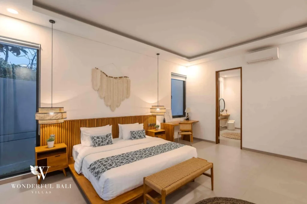 A king bedroom with a study nook and an open ensuite bathroom visible beyond at a 4-bedroom villa in Pererenan, Bali