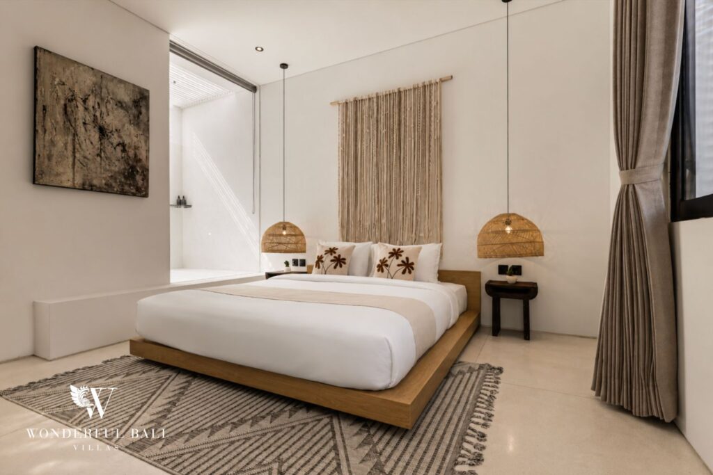 En-suite king bedroom with round mirrors at a villa in Petitenget, Seminyak