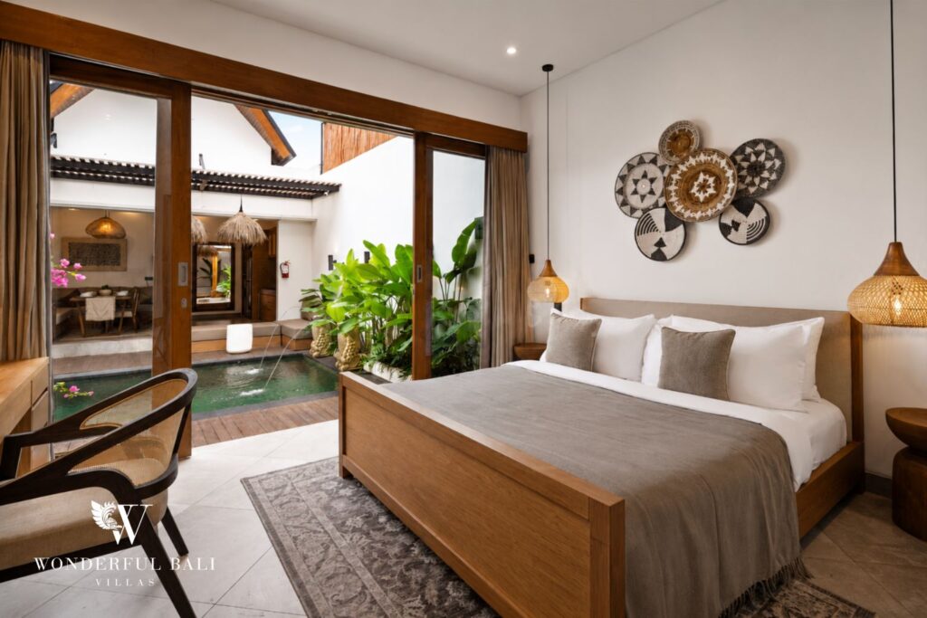 En-suite king bedroom with timber headboard at a villa in Canggu