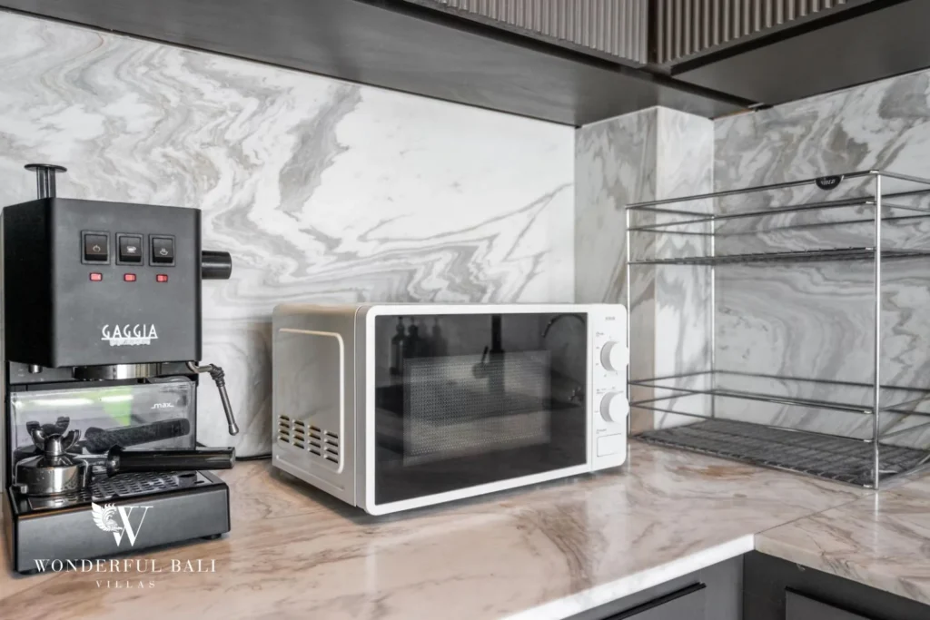 Kitchen countertop detail with an espresso machine and microwave on marble surfaces at a 5-bedroom villa in Pererenan, Bali