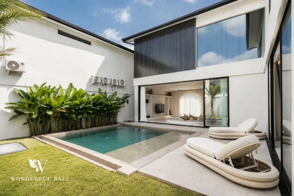 Private pool, lawn and sun loungers of a modern villa in Umalas, Bali