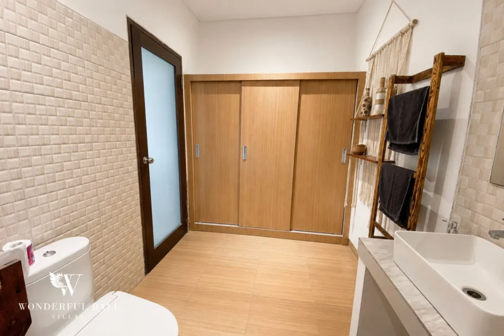 En-suite bathroom with sliding door and towel ladder at a villa in Batu Bolong, Canggu
