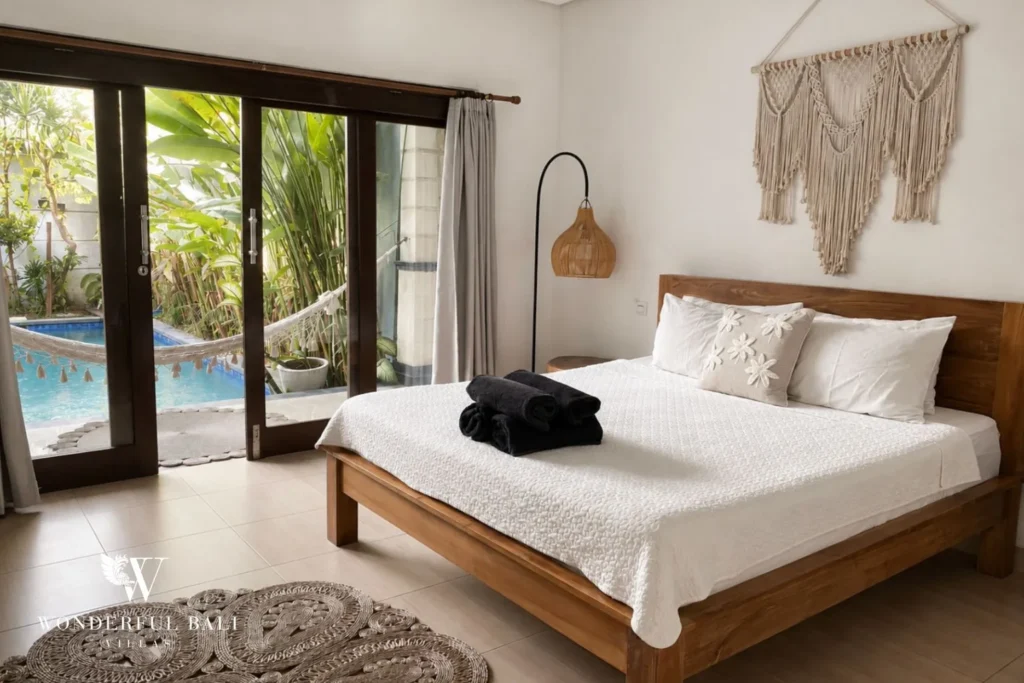 Boho bedroom with macrame wall and timber console at a villa in Batu Bolong, Canggu