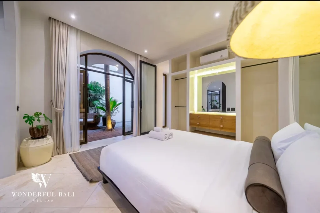 Bedroom opening onto the palm courtyard in a 4-bedroom villa in Canggu Bali
