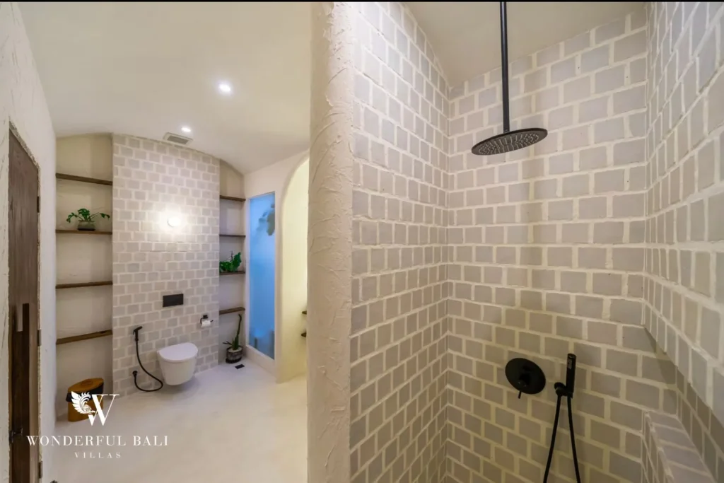 Walk-in rain shower lined in pale brick tile at a 4-bedroom villa in Canggu Bali