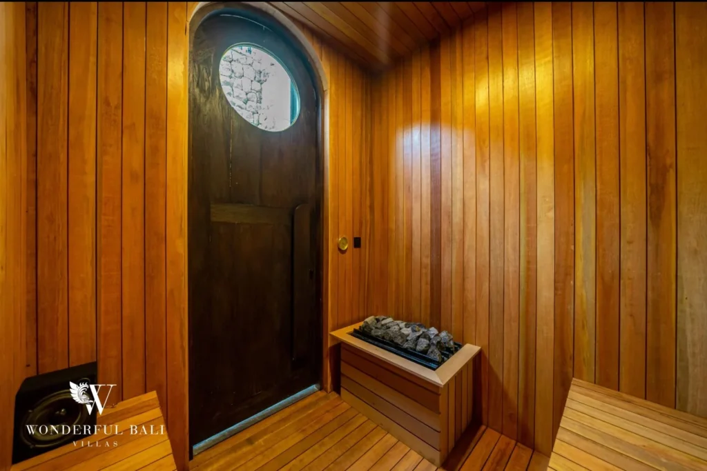 Timber-lined private sauna with stone heater at a 4-bedroom villa in Canggu Bali