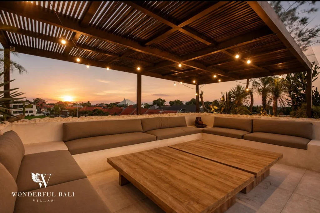 Rooftop lounge with festoon lighting at sunset at a 4-bedroom villa in Canggu Bali