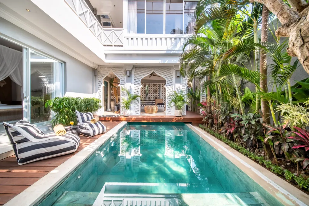 Villa Moana, Canggu — pool, striped poolside daybed beside the pool at Villa Moana, Canggu