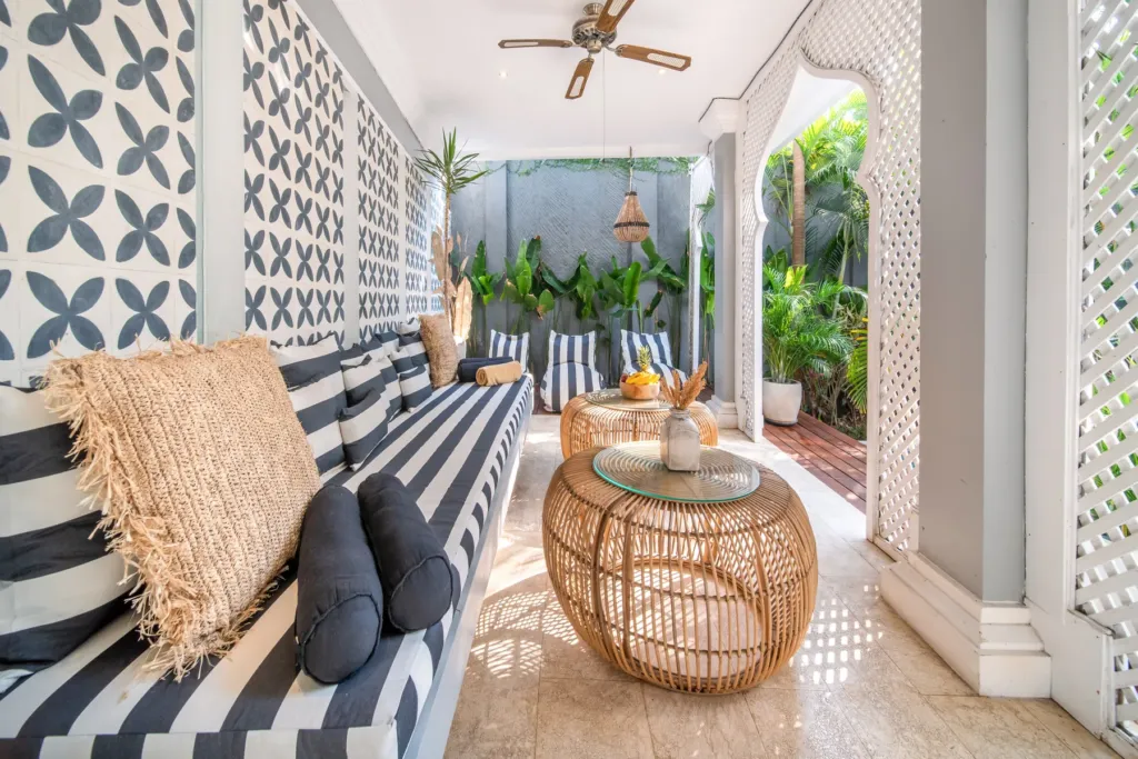 Villa Moana, Canggu — living room, shaded outdoor lounge at Villa Moana with ceiling fan and woven cushions