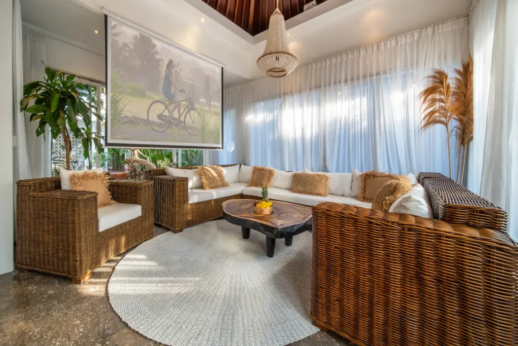 Villa Moana, Canggu — living room, corner at Villa Moana with artwork and rattan armchairs