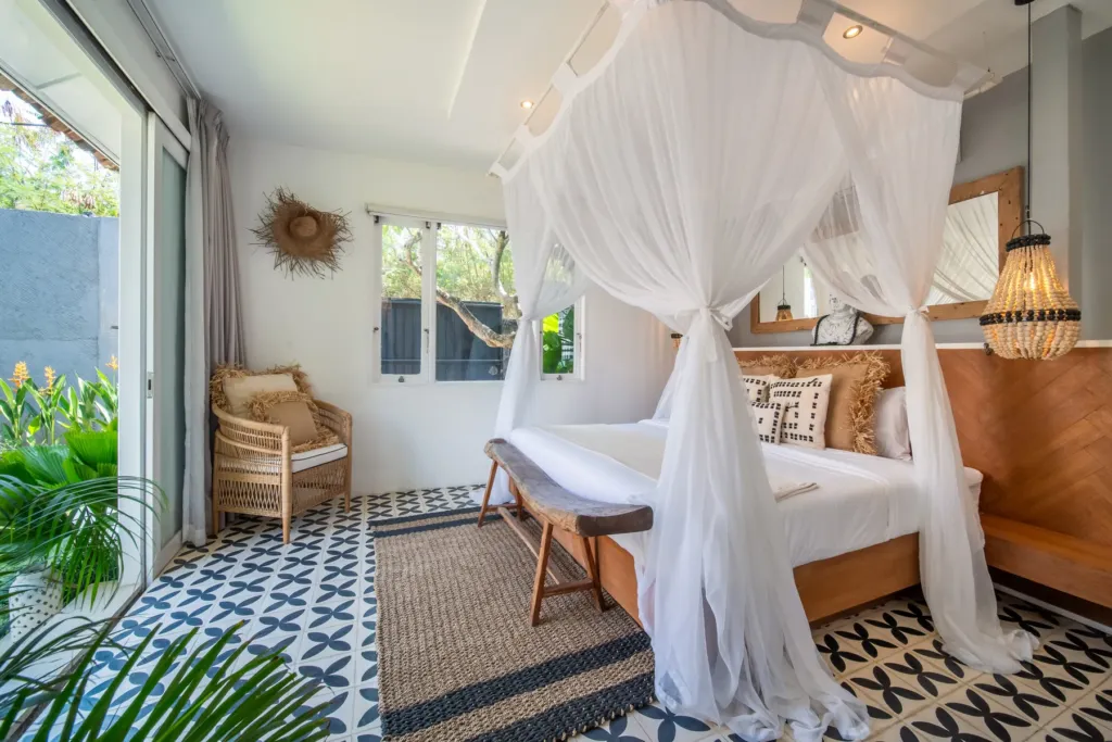 Villa Moana, Canggu — bedroom, at Villa Moana with sliding doors opening onto the lawn