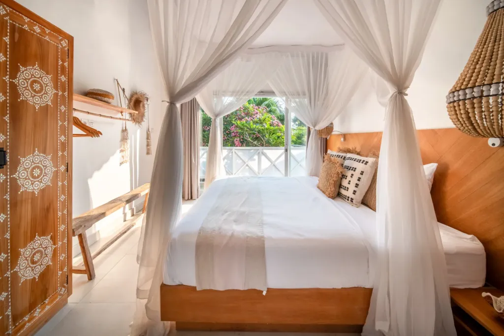 Villa Moana, Canggu — bedroom, king master bedroom at Villa Moana with garden window and mosquito net canopy