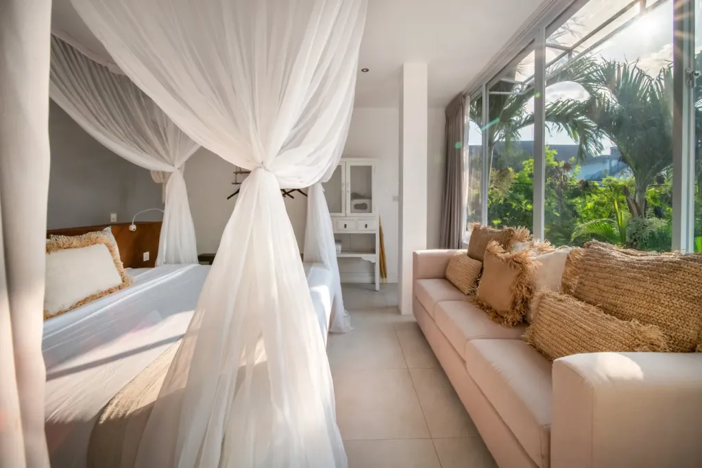 Villa Moana, Canggu — bedroom, king bedroom at Villa Moana with a full-height window onto the palm garden
