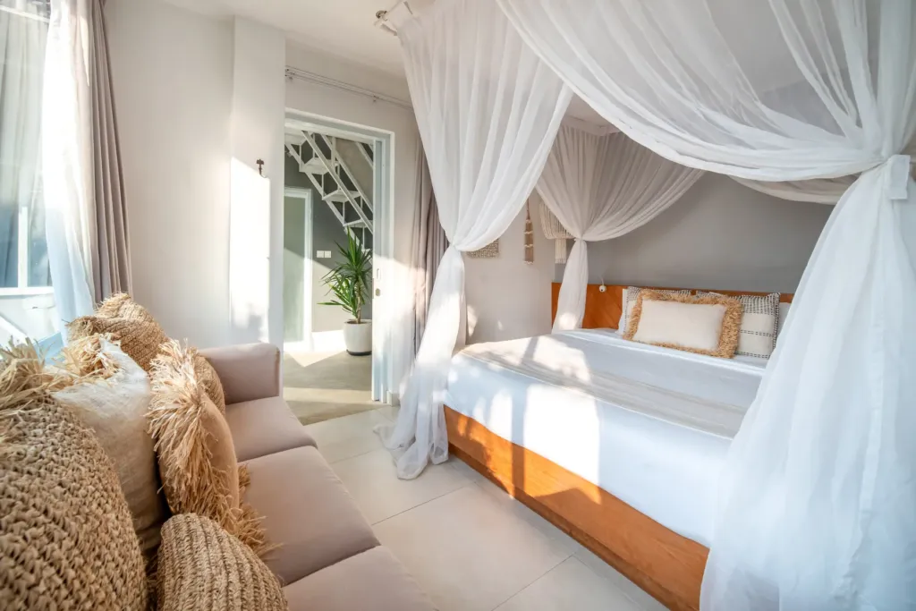 Villa Moana, Canggu — bedroom, bright king bedroom at Villa Moana with woven cushions and sheer curtains