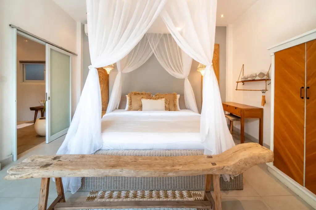 Villa Moana, Canggu — bedroom, canopy king bed at Villa Moana with a reclaimed timber bench at its foot