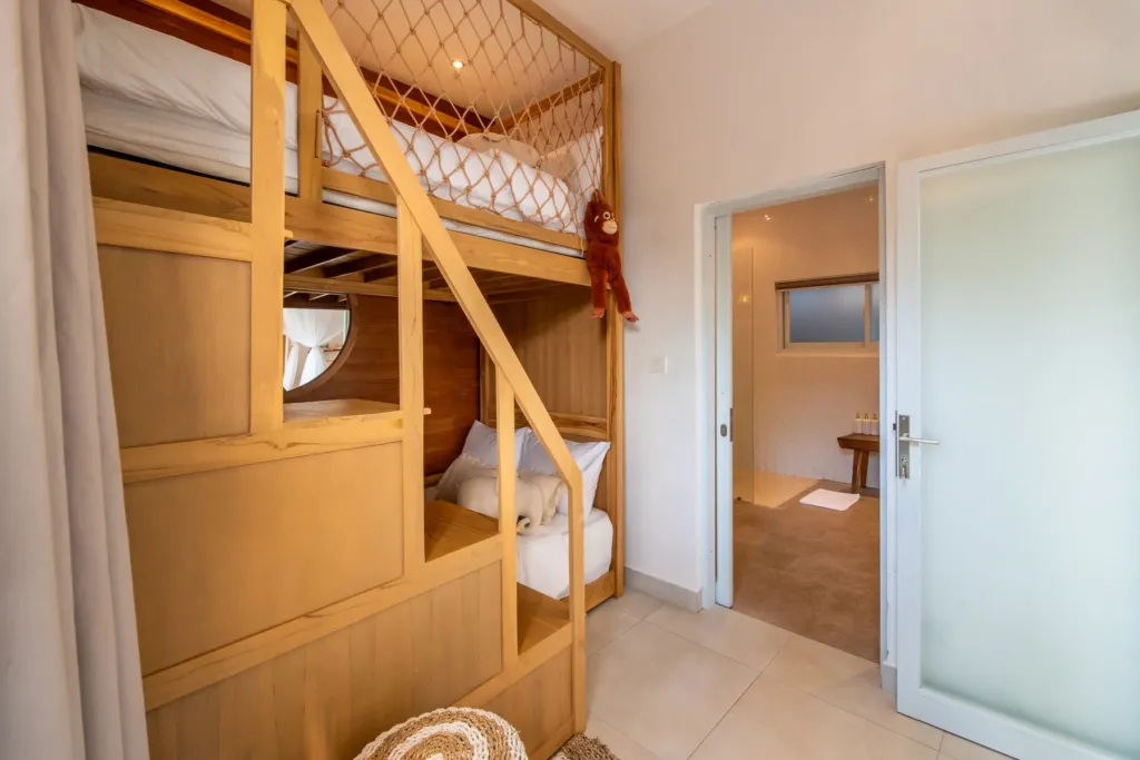 Villa Moana, Canggu — bedroom, bunk beds with a ladder and storage steps in the kids' room