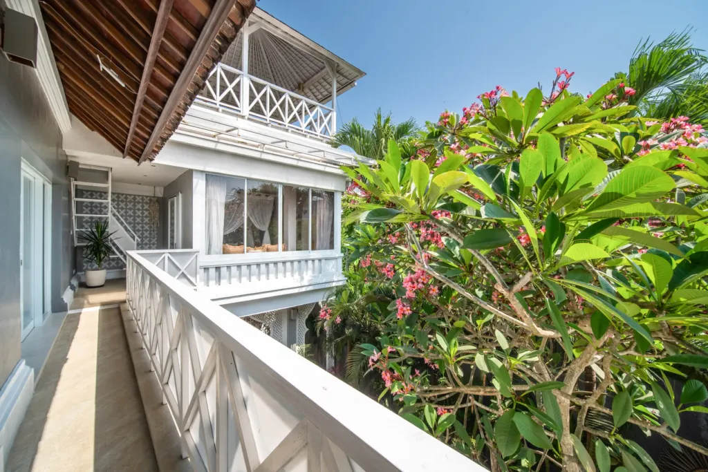 Villa Moana, Canggu — terrace, upper terrace walkway at Villa Moana with frangipani in flower