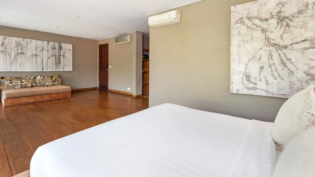 Master bedroom at Villa Yoga opening onto the shared teak terrace
