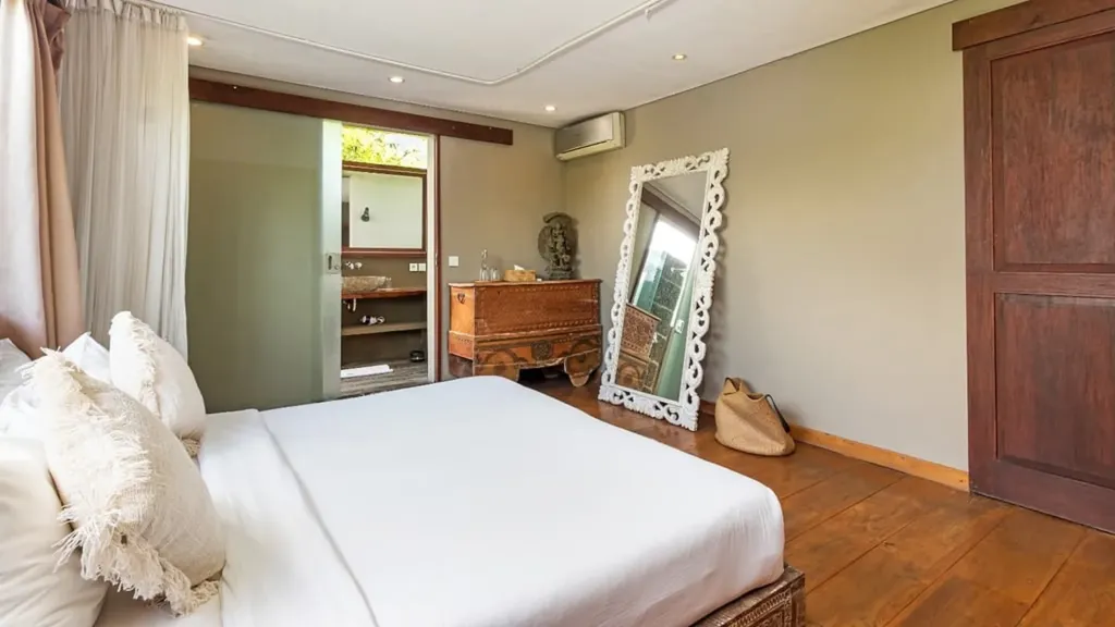 Bedroom 3 at Villa Yoga with canopy netting and carved teak furniture