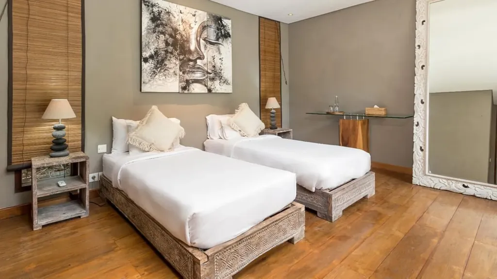 Bedroom 5 at Villa Yoga set up as twins, with timber floors and mirror