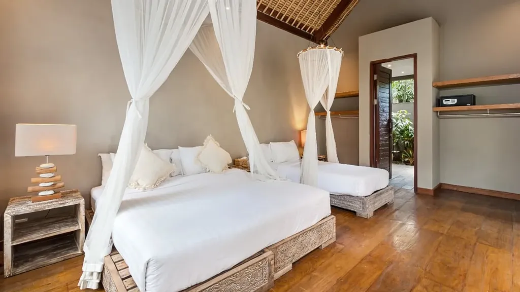 Bedroom 7 at Villa Yoga with a four-poster bed under an alang-alang roof