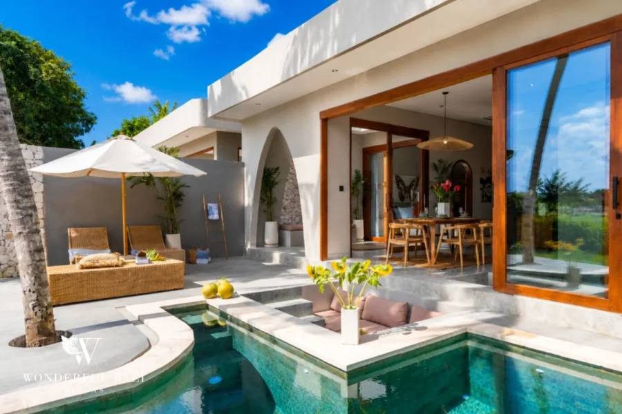 Private pool beside an open living pavilion with folding glass doors at a 2-bedroom villa in Pererenan Bali