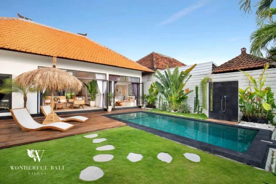 Black-tiled lap pool and teak deck under a terracotta roof at a 3-bedroom villa in Umalas Bali