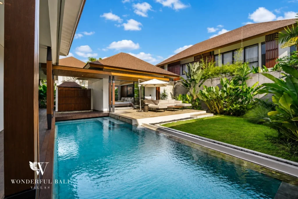 Lap pool running to a covered pavilion lounge at a 3-bedroom villa in Jimbaran Bali