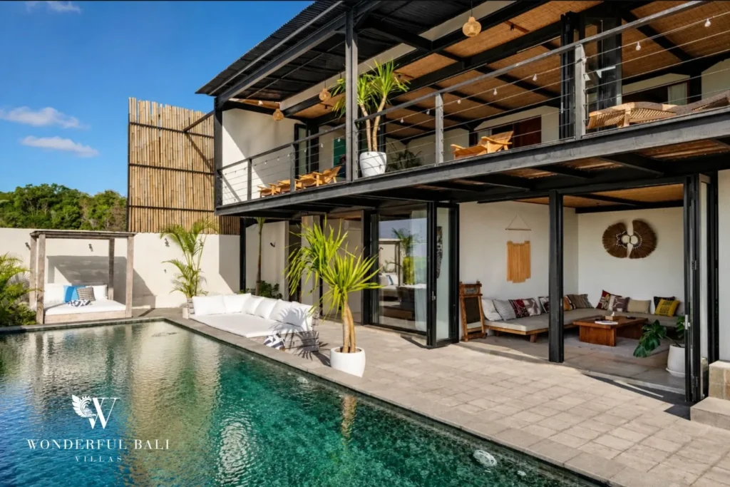 Long pool beside a black steel and rattan villa in Uluwatu Bali