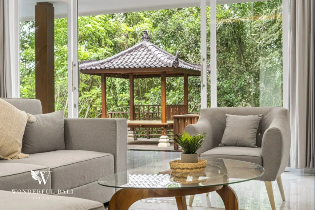 Living room looking out to the timber bale and jungle in a 3-bedroom villa in Kaba-Kaba Bali