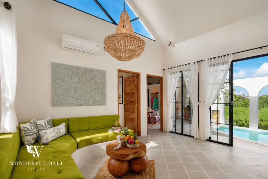 Living room with vaulted ceiling skylight and green velvet banquette in a 2-bedroom villa in Buduk Canggu Bali