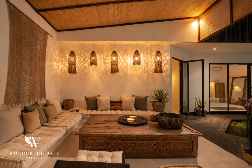 Open-air lounge with built-in seating and rattan pendants under a bamboo ceiling in Umalas Bali