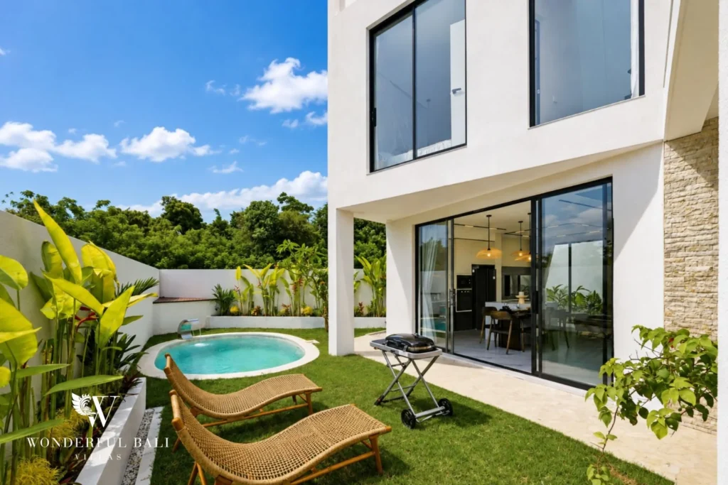 Rattan sun loungers on the lawn beside the private pool at a 3-bedroom villa near Nusa Dua Bali