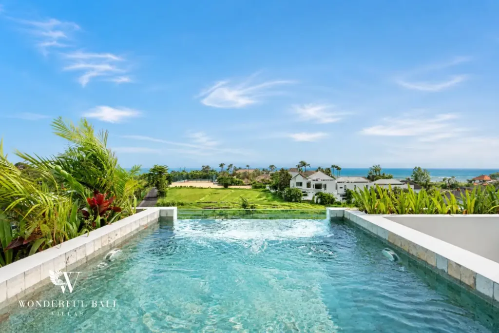 Rooftop plunge pool looking over rice fields to the ocean at a 3BR villa in Pererenan Bali